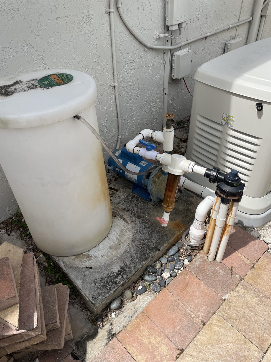 Before: existing irrigation pump, pressure tank and corroded pipes before relocation — Miramar, FL