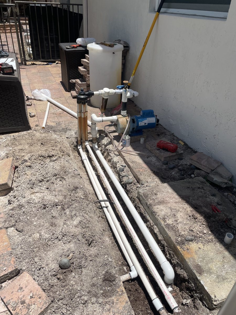 During: irrigation pump, pressure tank and manifold reassembled in new location — Miramar, FL