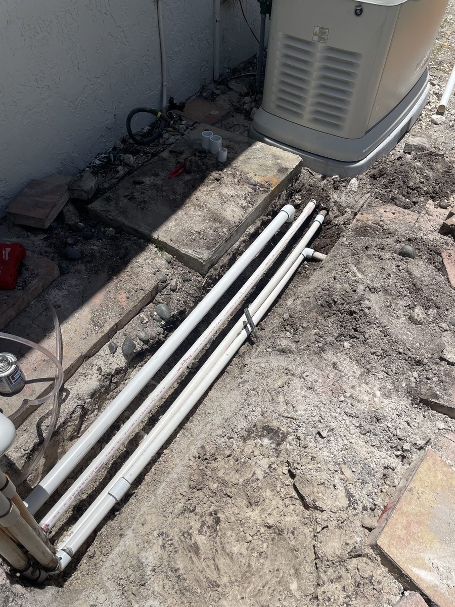 During: new PVC irrigation mainlines laid in trench for pump relocation — Miramar, FL